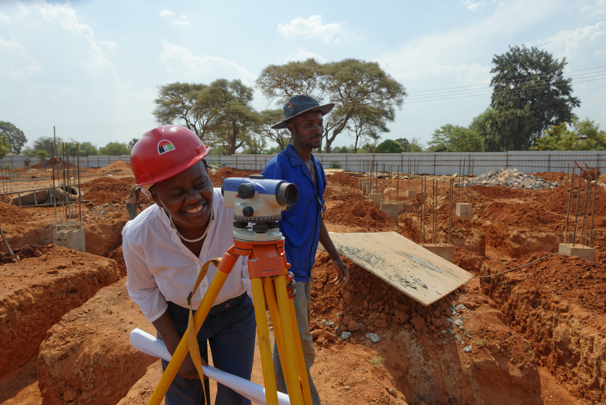Des ouvriers utilisant du matériel de topographie sur un chantier en Zambie