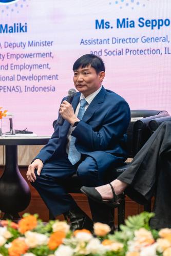 Heng Sour, Minister of Labour, Cambodia Man sitting on a dais