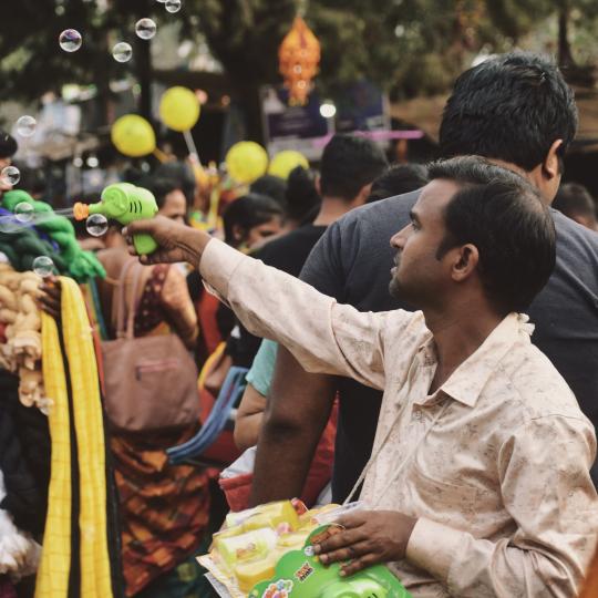 A man selling bubbles somewhere in India.