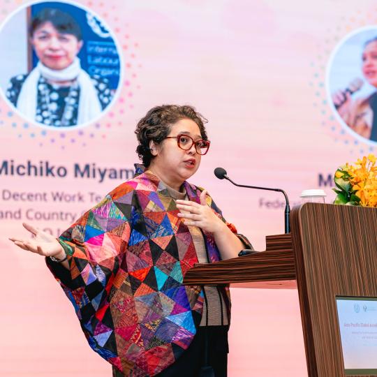 Woman standing at a dais