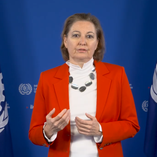 Woman standing in front of ILO backdrop