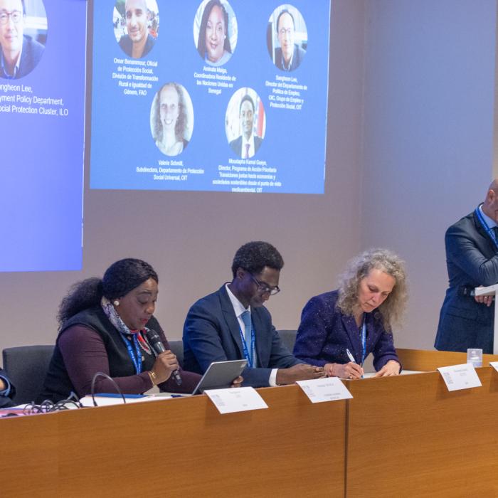 Women and men at a dais 