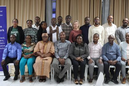 Women and men sitting together at a dais of a workshop
