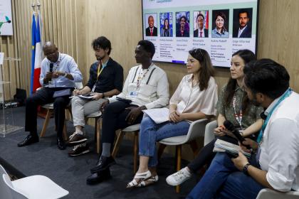 Women and men at a dais  