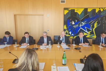 A group of men and women at a roundtable meeting