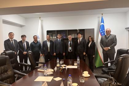 Men and women standing at a meeting