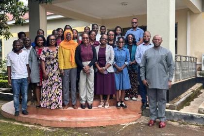 Women and men standing together outdoors 
