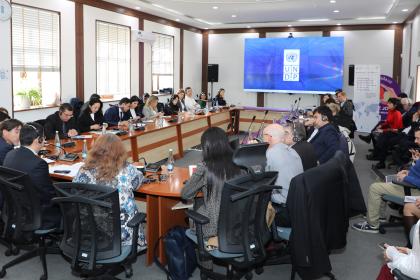 Women and men in a roundtable meeting 