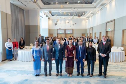 Women and men standing together for a group photo