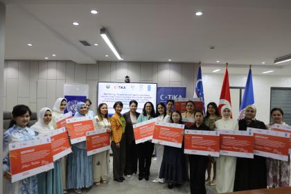 Women standing together with their certificates