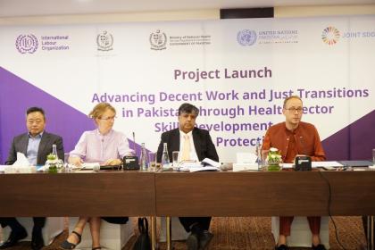 Women and men sitting on the dais 