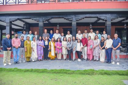 Group photo of women and men standing outside