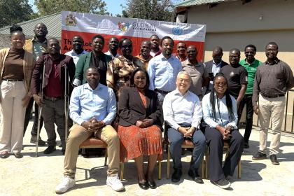 Group photo of women and men sitting outside