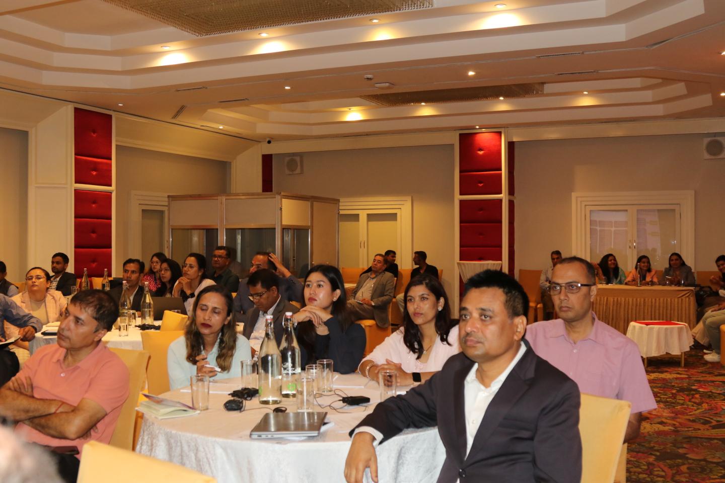 Audience in a conference room of a panel discussion