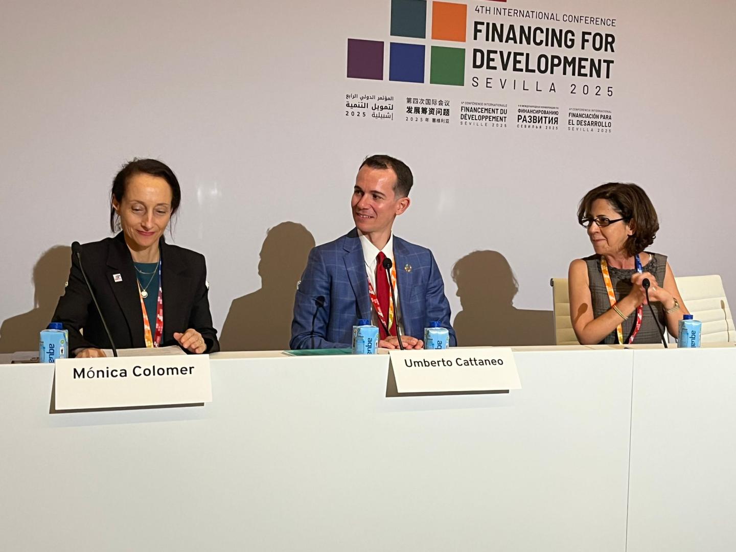 Women and men at a dais
