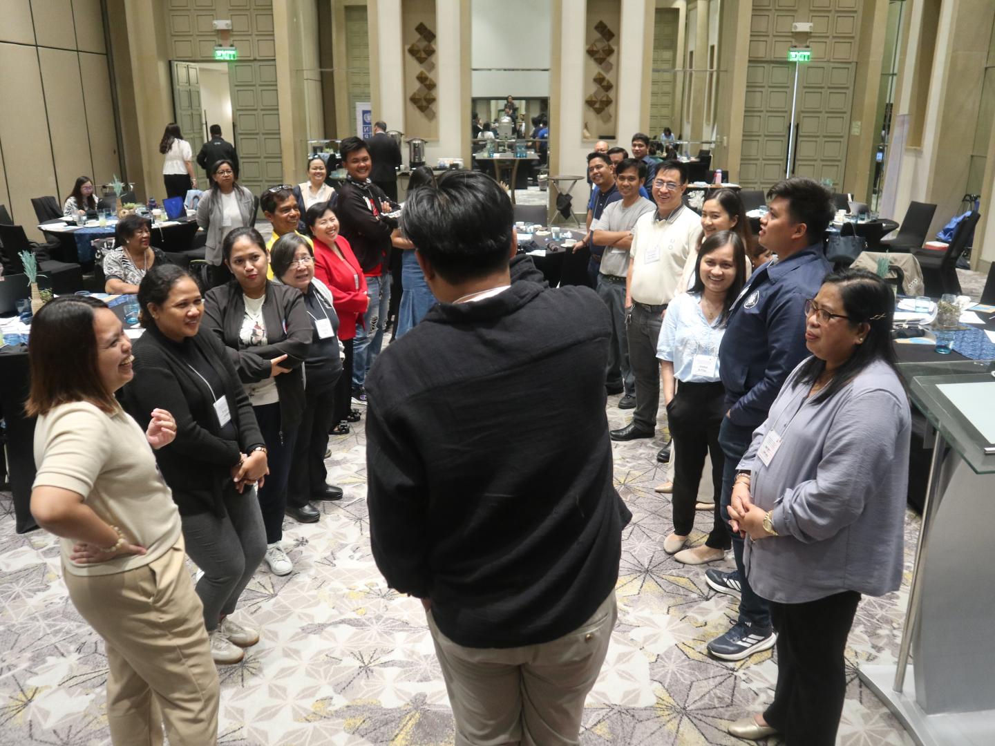Women and men standing in a group during a discussion