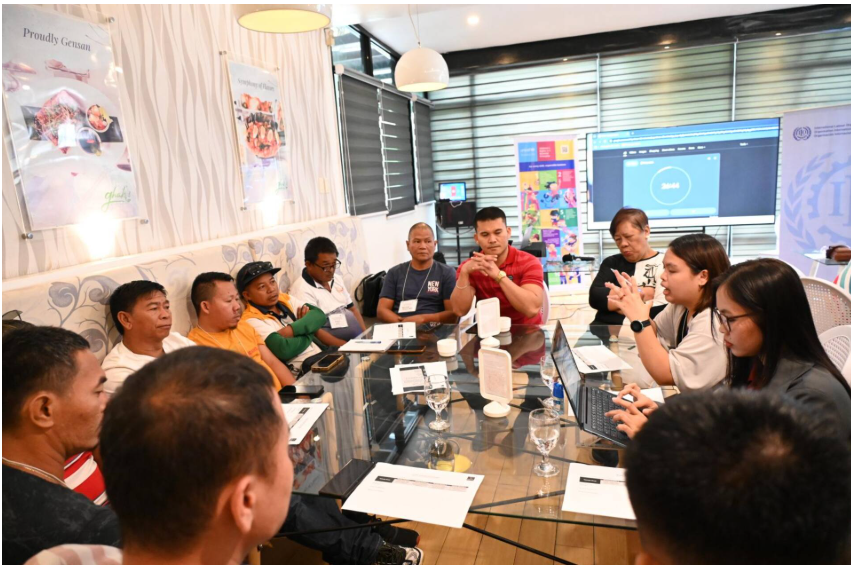Women and men sitting around a table in discussion