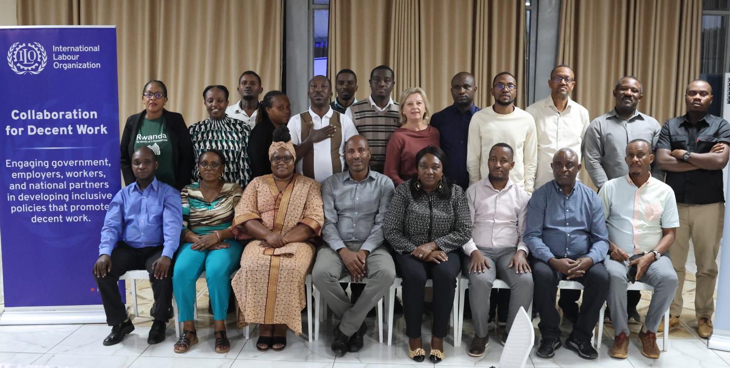 Women and men sitting together at a dais of a workshop