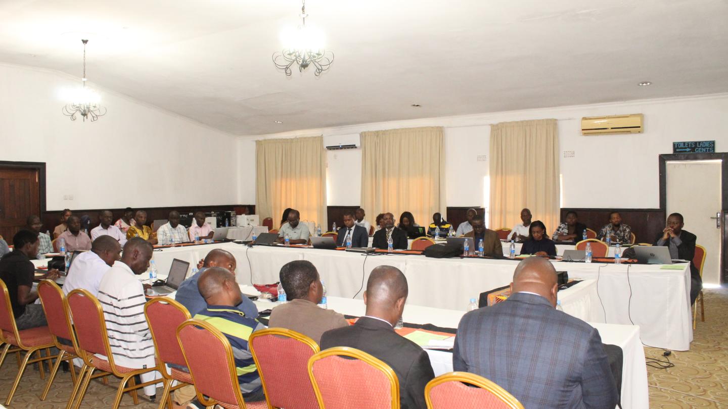 Women and men sitting in a conference room