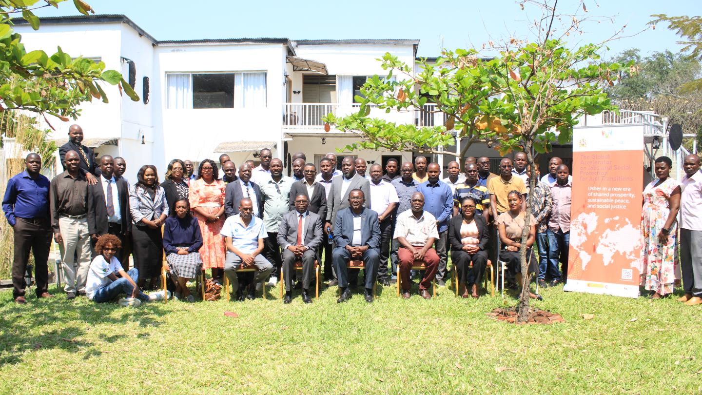 Women and men in a group photo outside 
