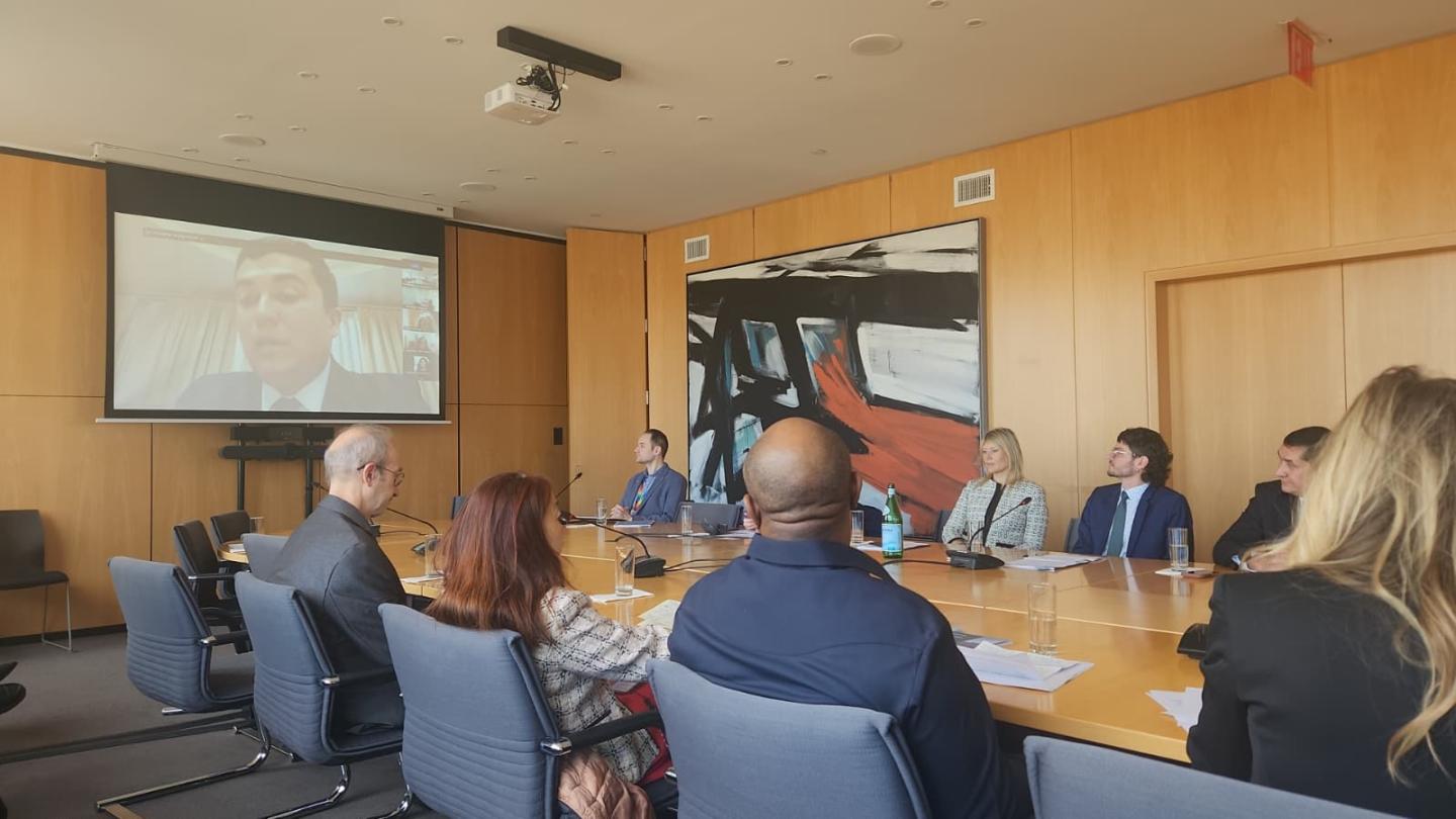 Women and men in a roundtable meeting