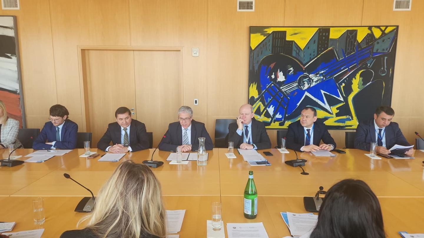 A group of men and women at a roundtable meeting
