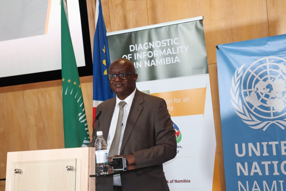 Man speaking at an event behind a podium