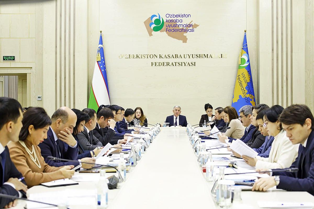 Women and men at a roundtable meeting