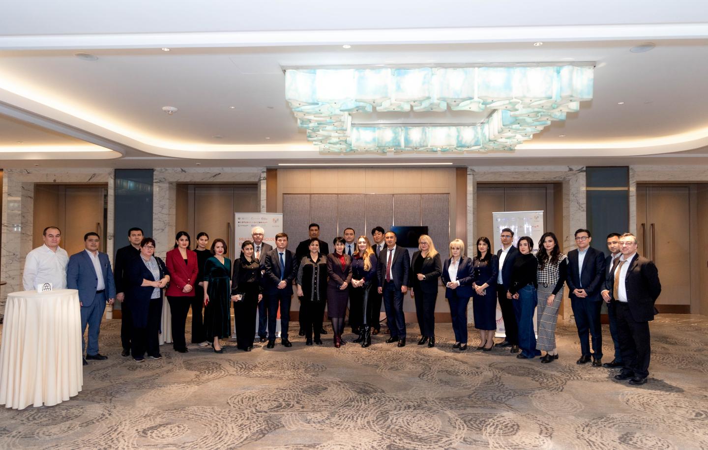 Women and men standing together for a group photo