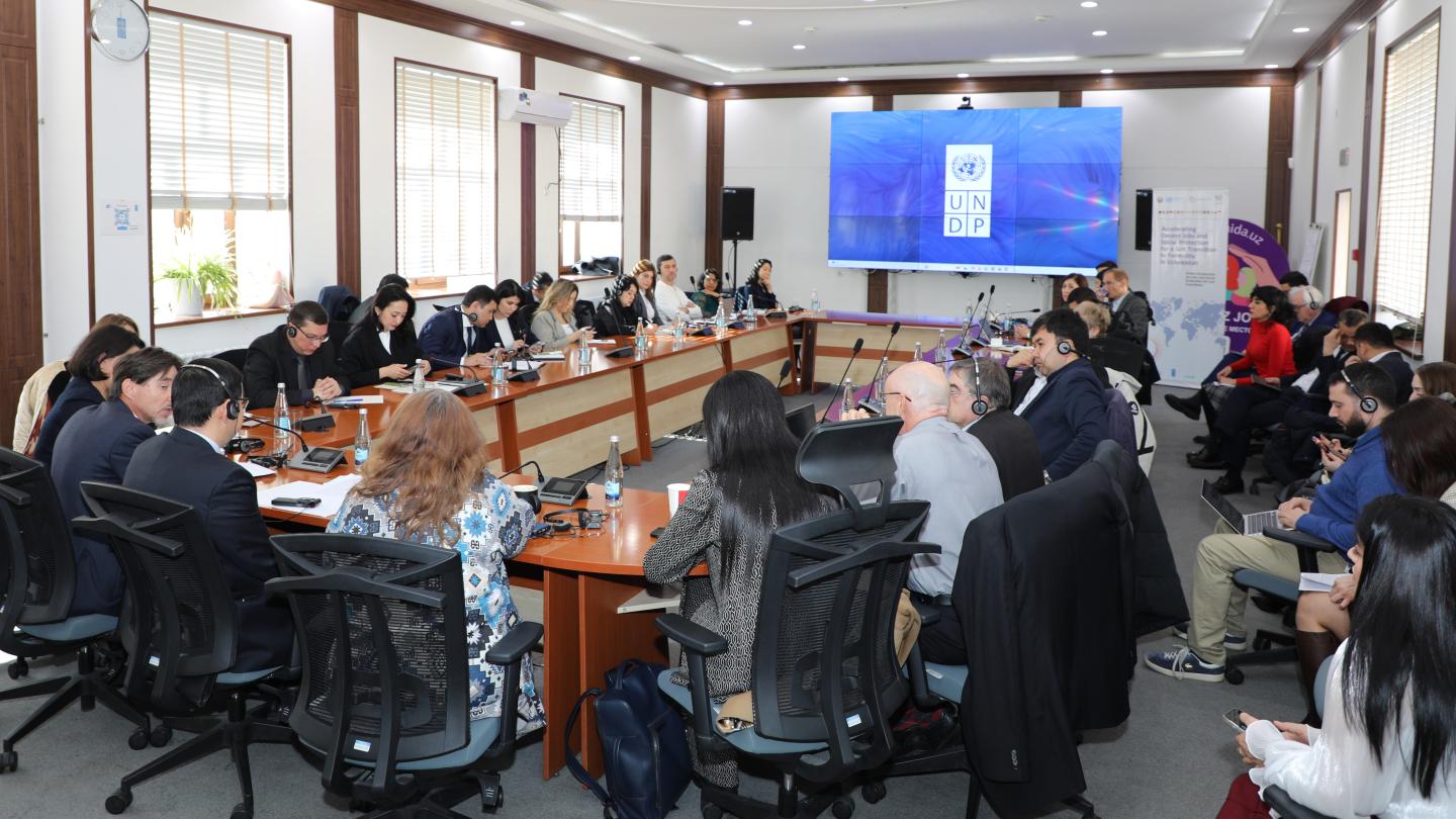 Women and men in a roundtable meeting 