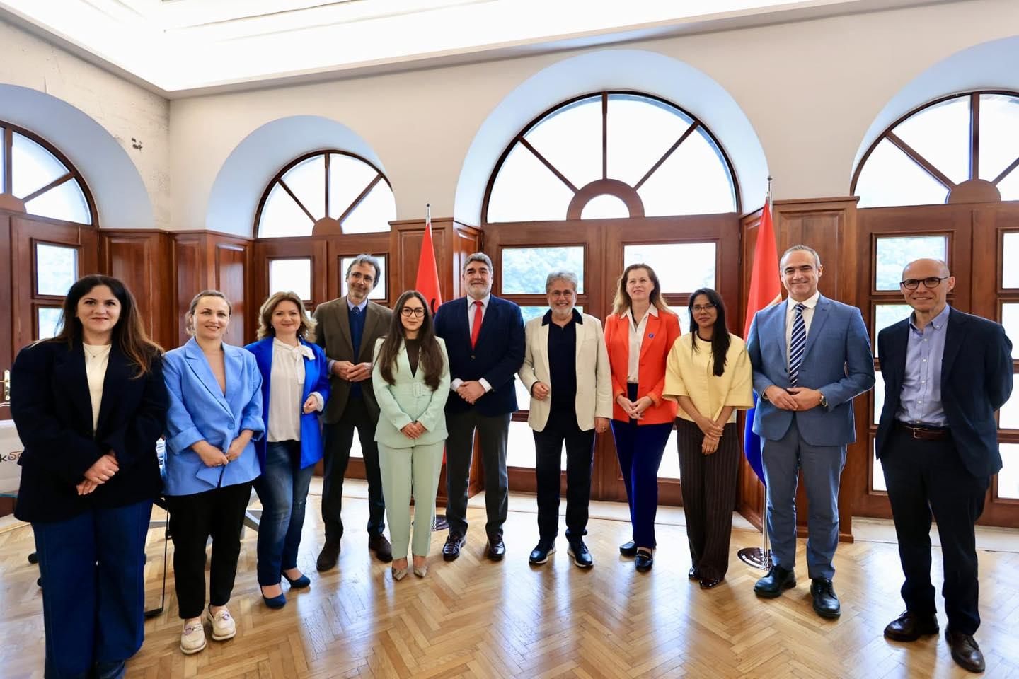 Women and men standing together for a group photo