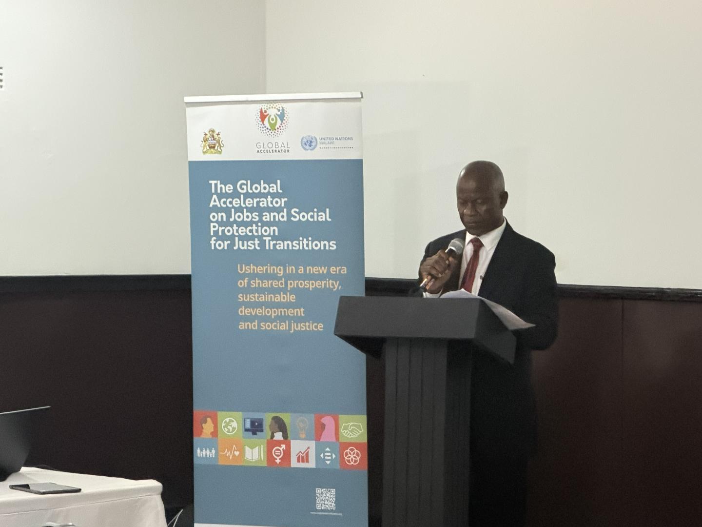 Man speaking behind a podium