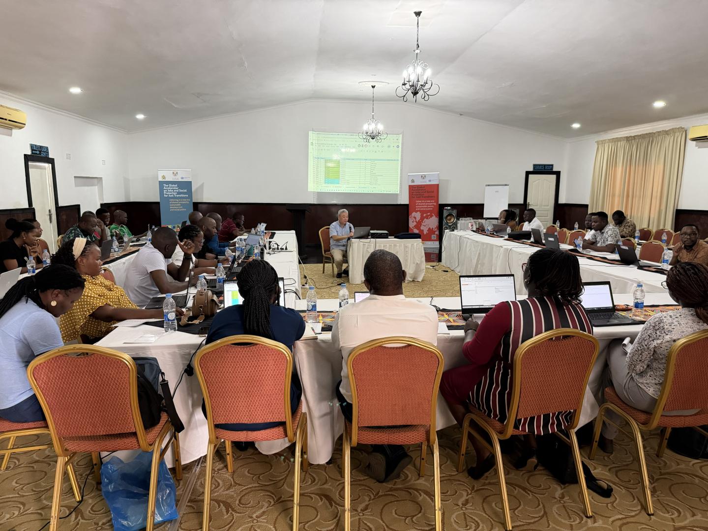 Women and men sitting for a workshop