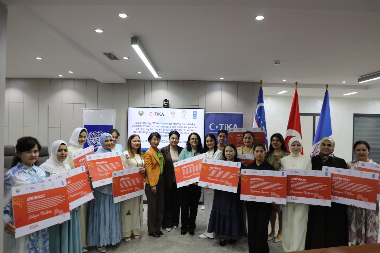 Women standing together with their certificates