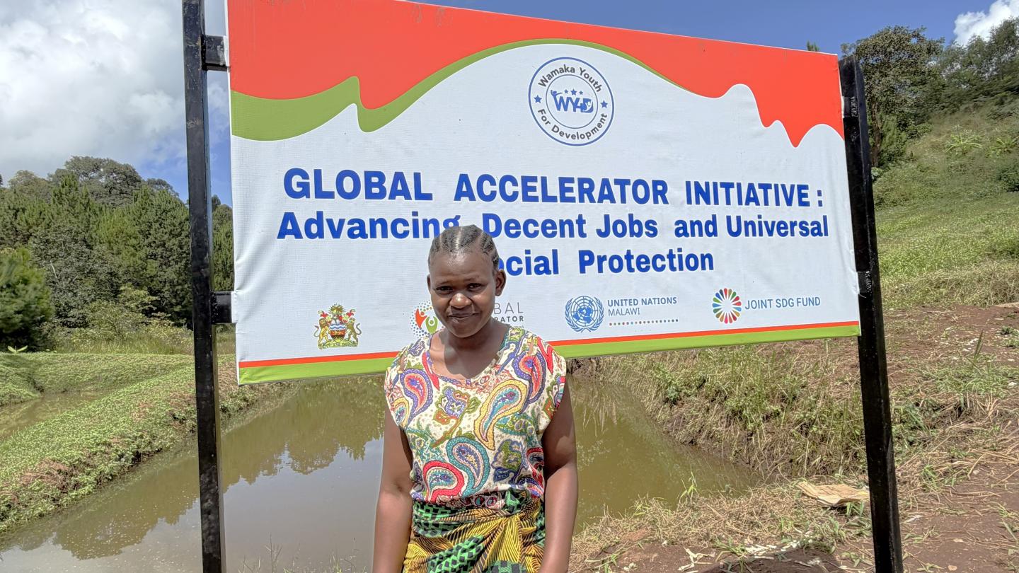 Woman standing in front of a banner in a farm