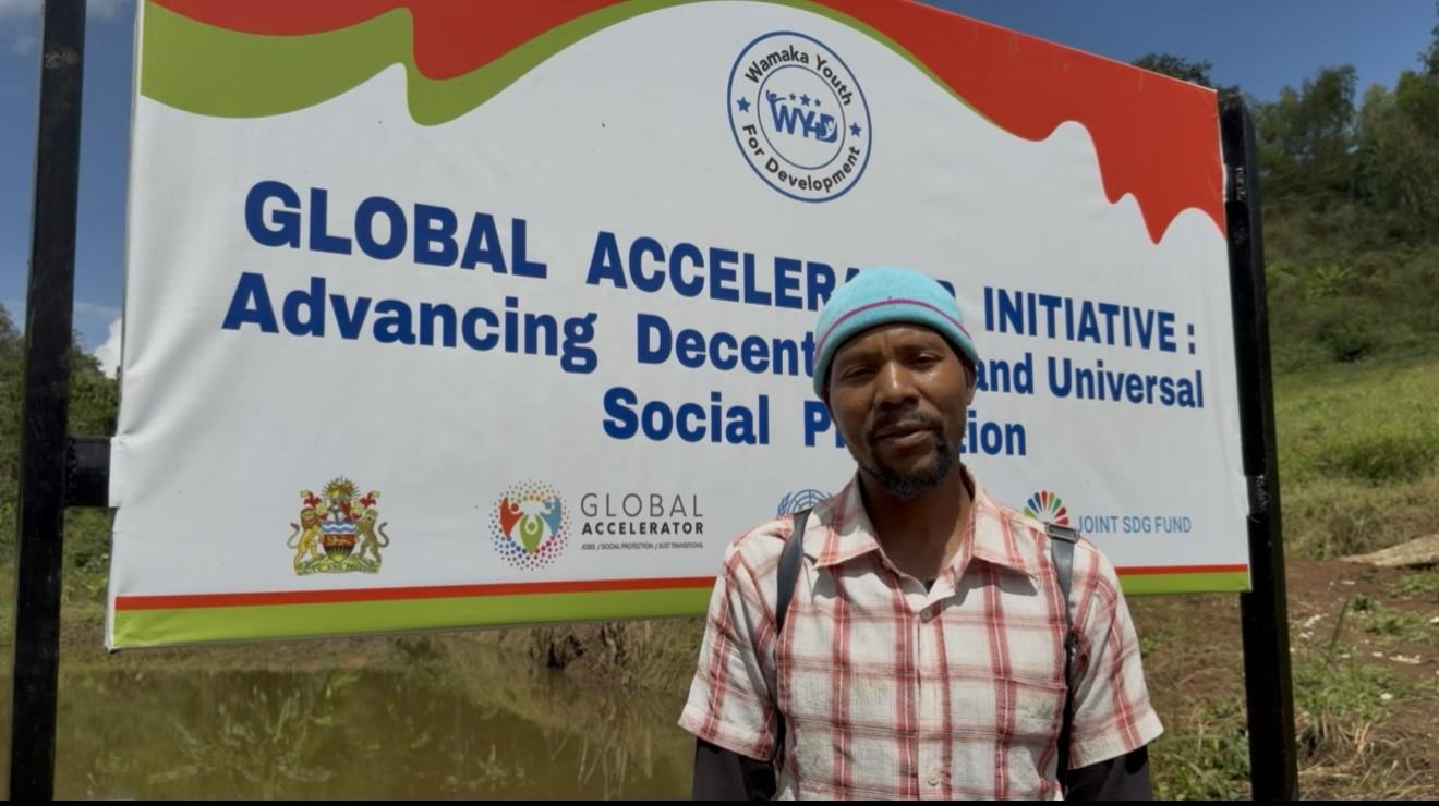 Man standing in front of a banner in a farm