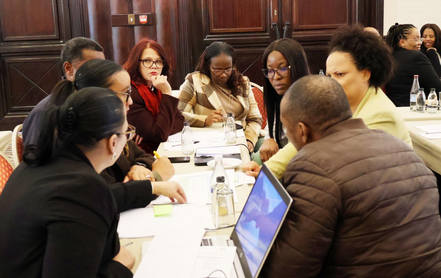Conference photo of women and men sitting 