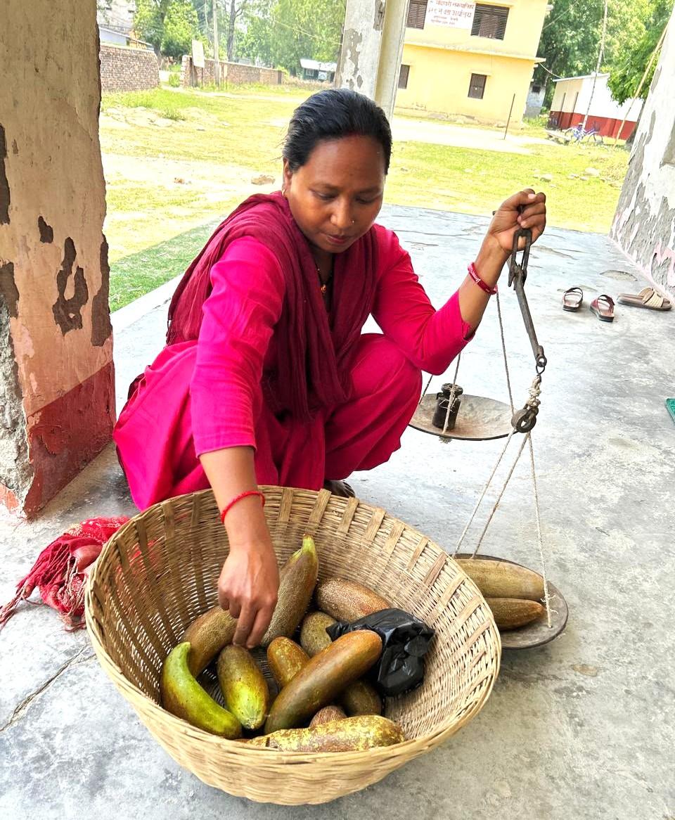 Woman sitting down and selling vegetables