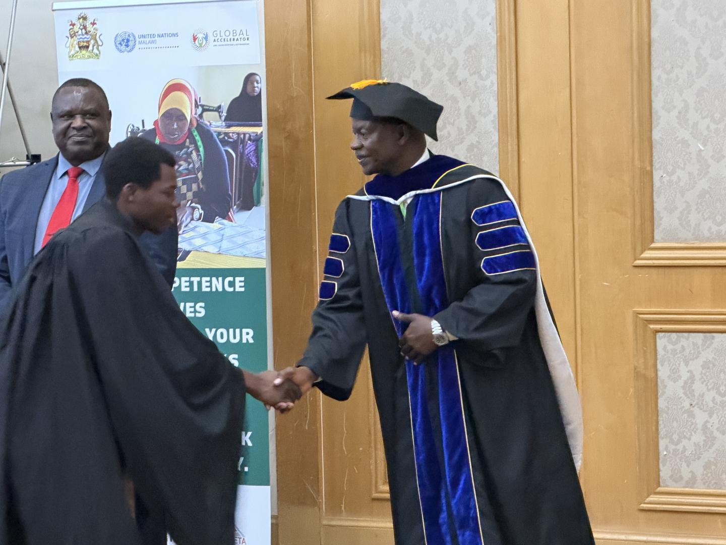 Man receiving a certificate from another man