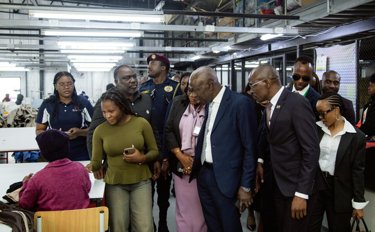 Women and men in a factory during a visit