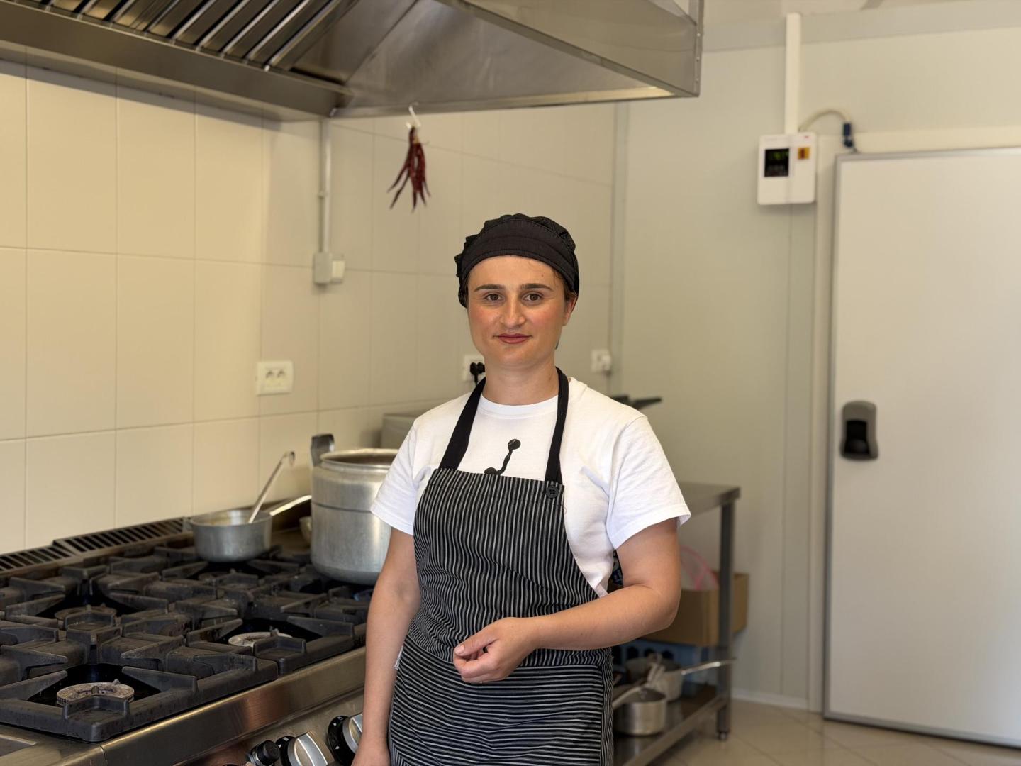 Woman standing in front of a stove