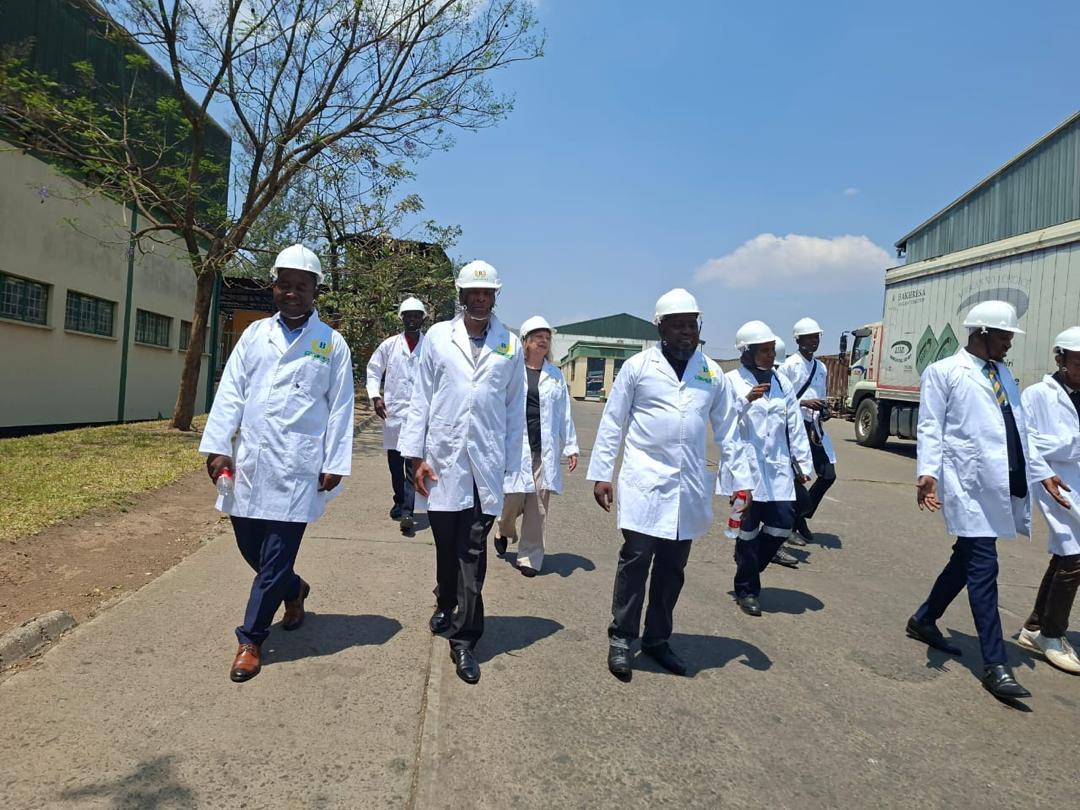 People with security equipment outside a factory