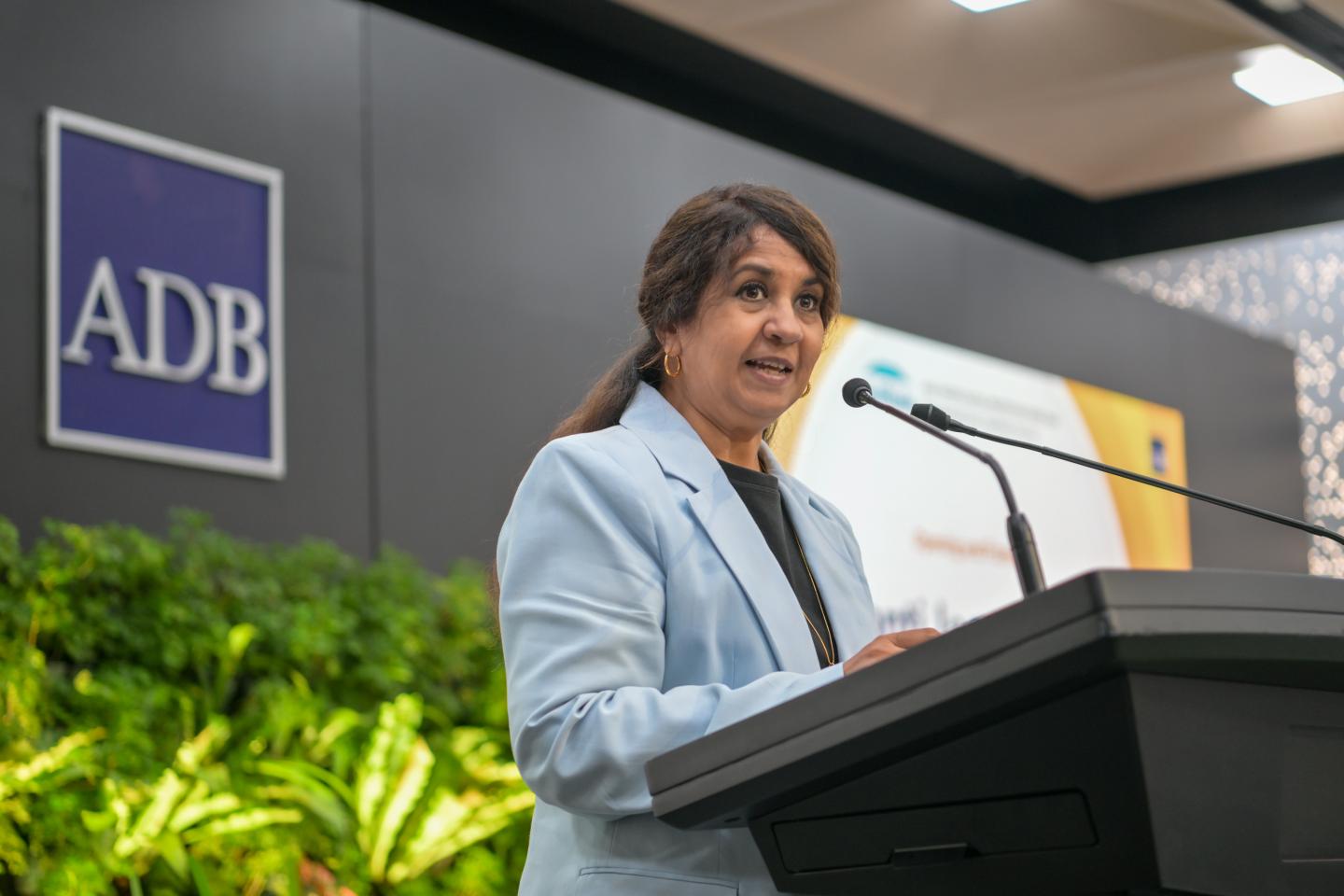 Woman speaking behind a podium