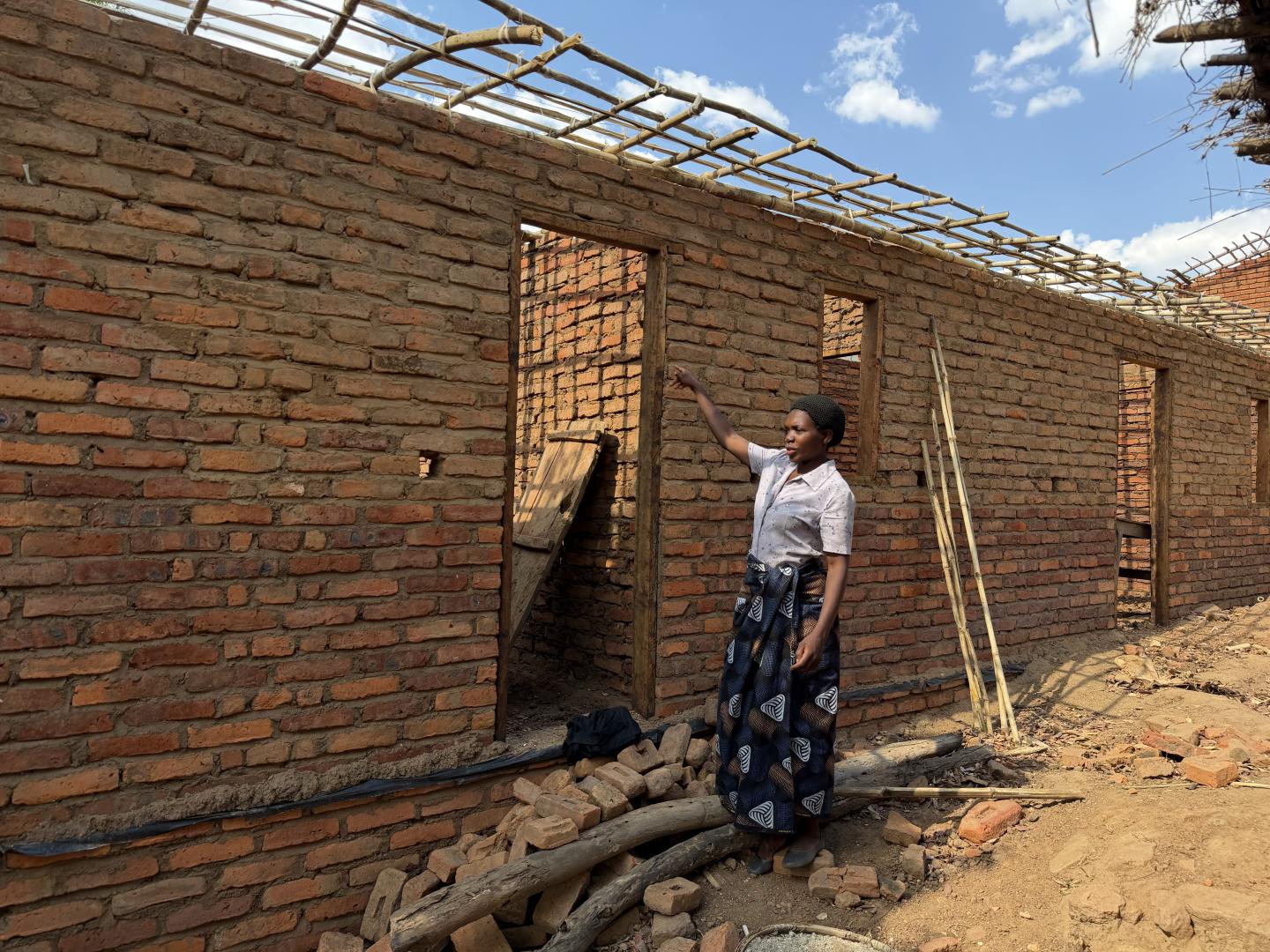 Woman standing next to a house