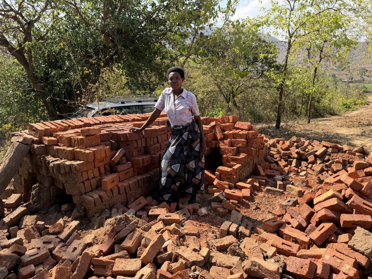 Woman standing next to bricks